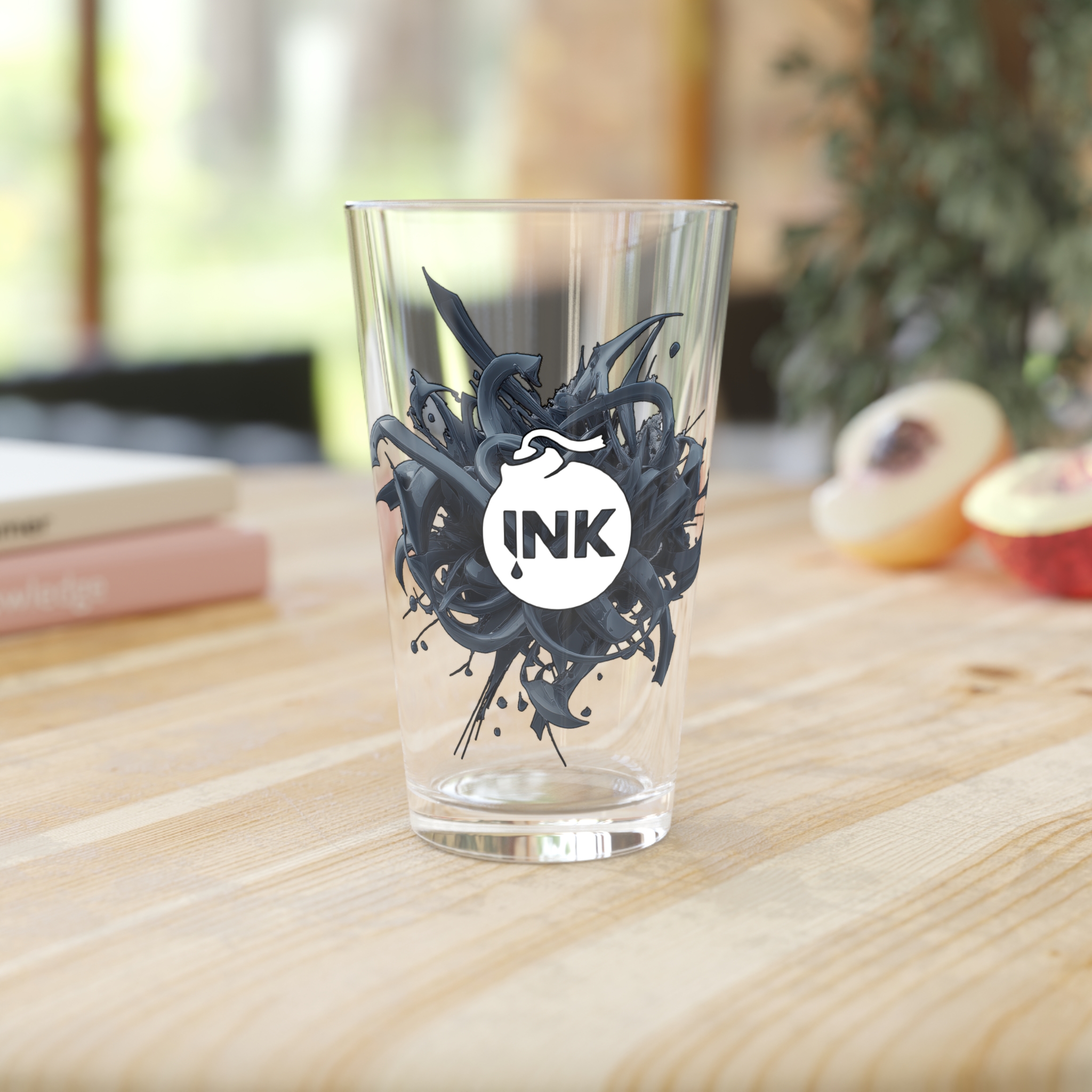 Product photography of the InkBomb Ink Splat 3D 16oz Pint Glass on a wooden table